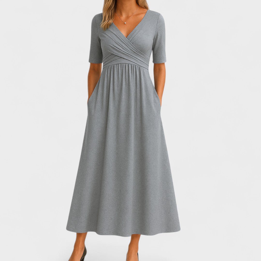 Elegant midi dress featuring a flattering fit, practical pockets, and a stylish surplice V-neckline, perfect for any occasion. 0